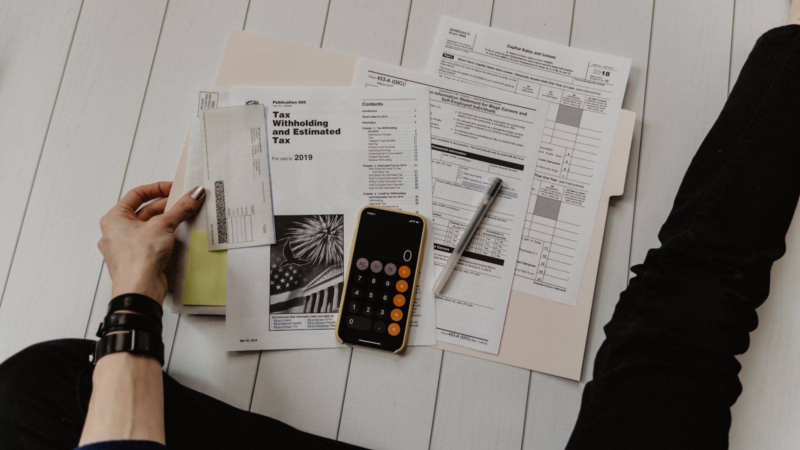 Calculator and notebook on desk for financial comparison